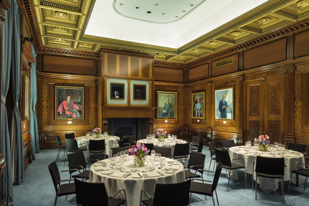 Four round tables adorned with dinner sets.