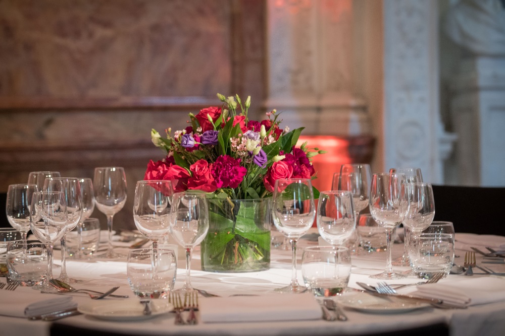 A white table adorned with dinner sets.