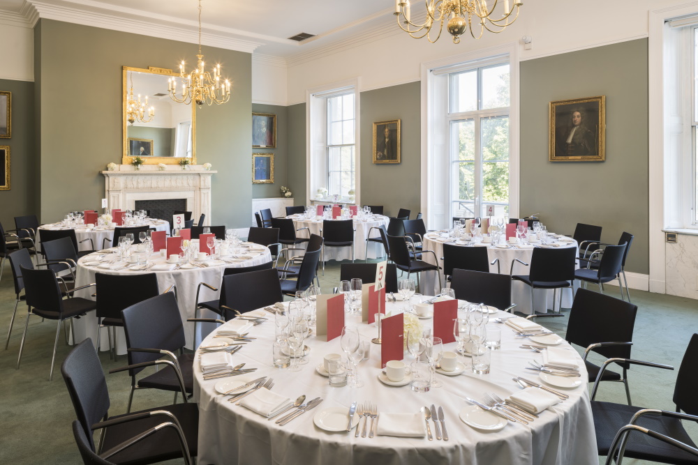 Round white tables set for dinner.