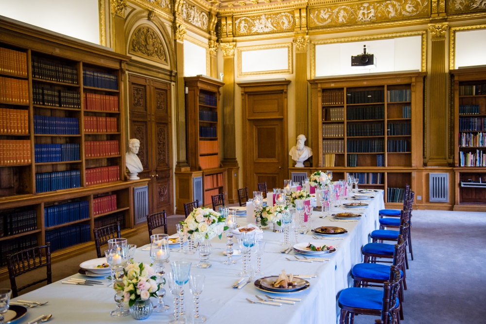 A large white table set for dinner.