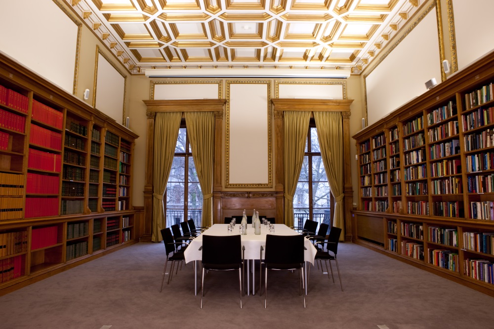 A boardroom table with a white tablecloth.