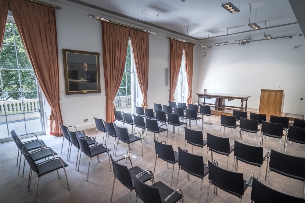 Black chairs organised in rows.